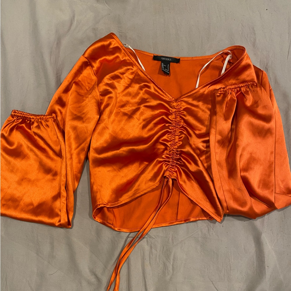 never worn, size small, satin material, elastic wrist sleeves